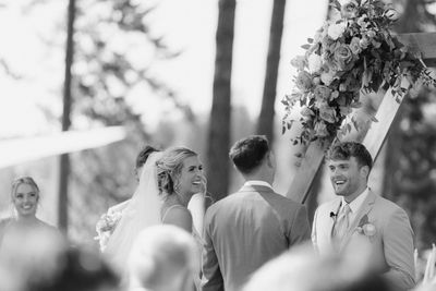 Joyful wedding ceremony with bride and groom exchanging vows outdoors.