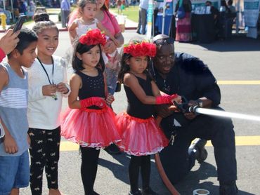 Gardena Harvest Festival letting kids spray water