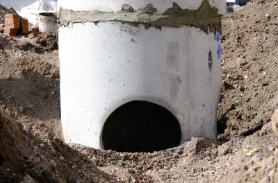 Close-up of a large concrete pipe opening at a construction site.