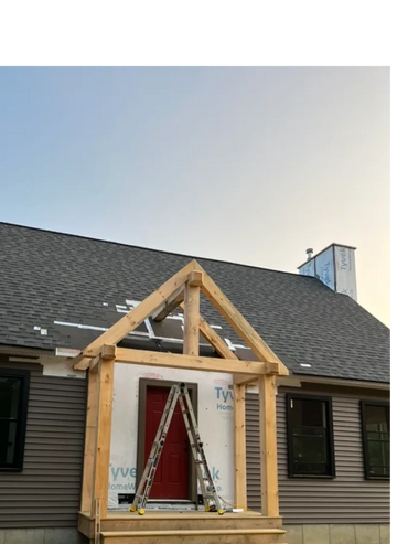 Timber framed entryway partially built (just beams)