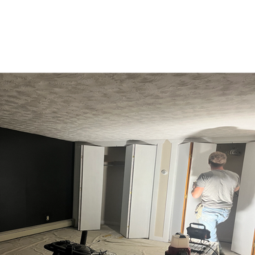 Man painting a closet door