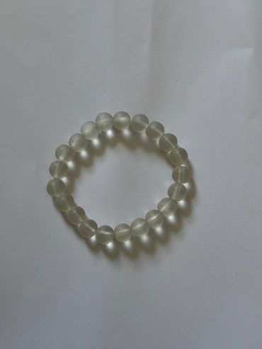 A translucent beaded bracelet on a plain white background.