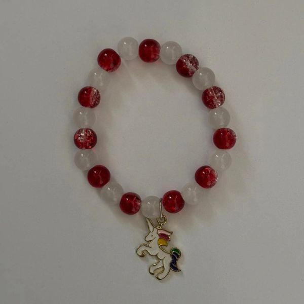 Red and white beaded bracelet with a colorful unicorn charm.