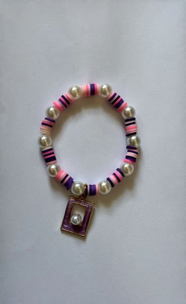 Beaded bracelet with pink, purple, and pearl beads and a purple rectangular charm.