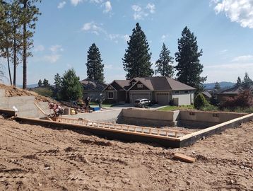 Construction workers building a concrete foundation on a sunny day.