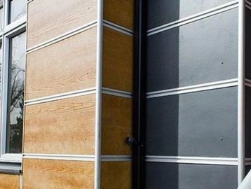 Modern building exterior with wood and dark paneling.