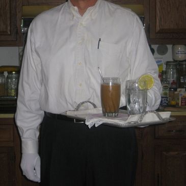 Waiter in white gloves holding a tray with drinks and napkins.