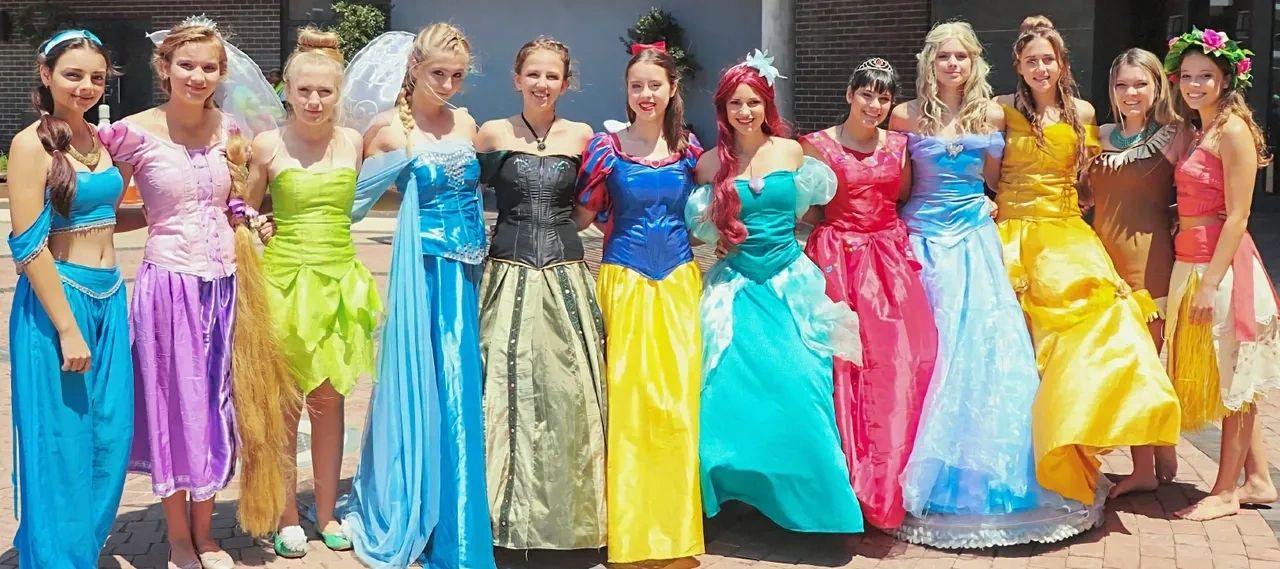 A group of girls dressed in princess dresses.