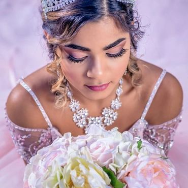 Young beautiful bride in wedding dress with a bouquet of flowers on nature