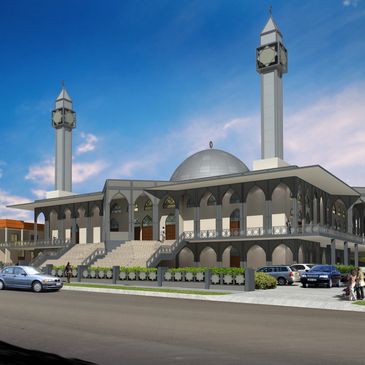 Modern mosque with twin minarets and a large dome under a clear blue sky.