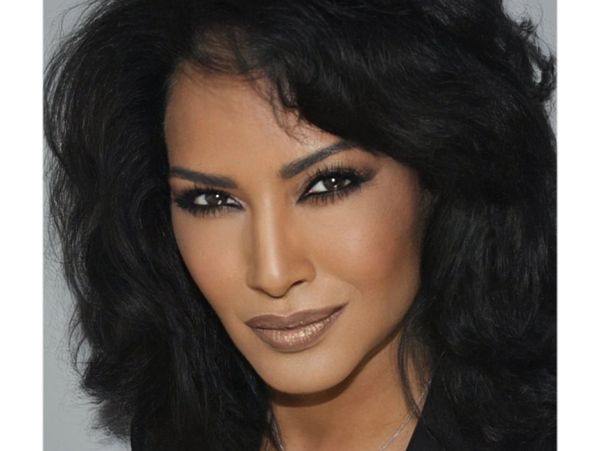 Close-up of a woman with dark hair and smoky eye makeup.