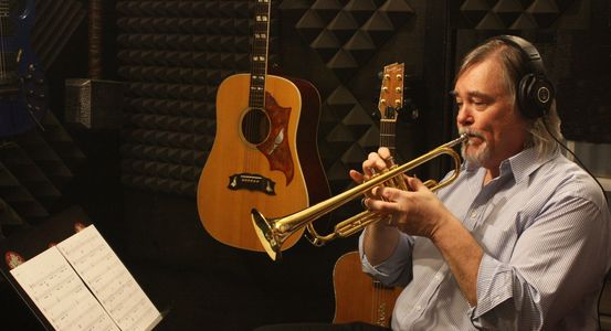 Image of Steve Hart playing trumpet in recording studio