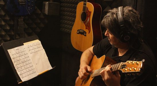 Image of Steve Rosas playing acoustic guitar