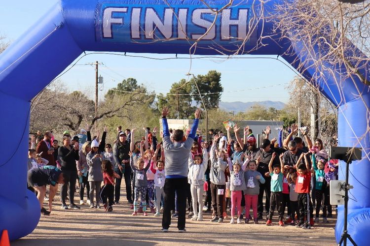 Start of a 5K race with people stretching.