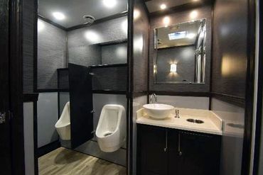 Interior luxury mobile restroom 2 urinals and sink area