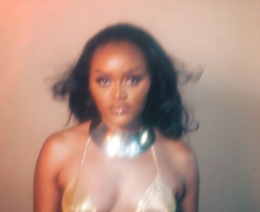 Iris Ilani in gold-beaded top with gold choker. Photo taken in Oakland, California.