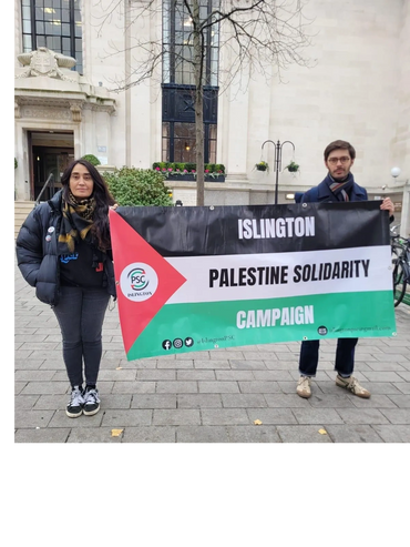 Two people holding a Palestine Solidarity Campaign banner in Islington.