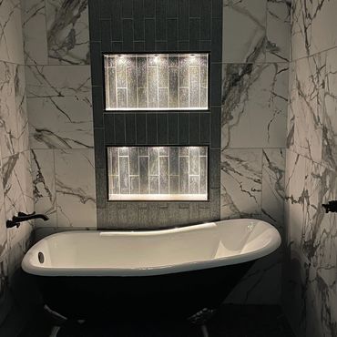 Elegant bathroom with a clawfoot tub and marble tiles.
