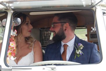 Bride and Groom driving off on their honeymoon in a VW Splitscreen Camper