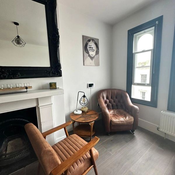 A scenic view of a sunset over a tranquil lake, reflecting vibrant orange and purple hues.