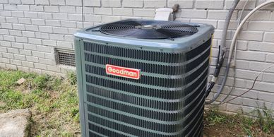 A Goodman brand outdoor air conditioning unit.