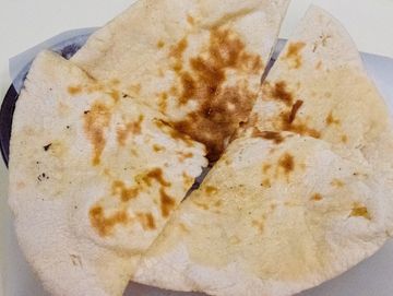 Traditional Indian bread baked in a Tandoori oven with cheese.