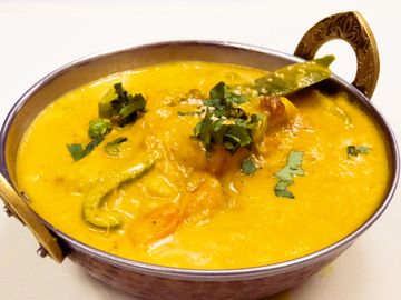 Pineapple cooked with shrimp, coconut milk, and curry spices.