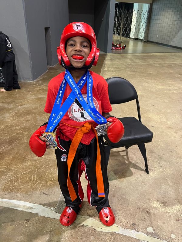 Young martial artist with medals and boxing gear.