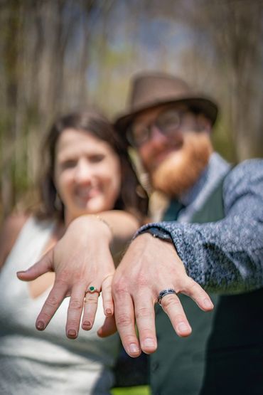 A young married couple shows off their rings.