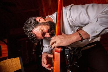 A stand-up bass player jams during a reception.