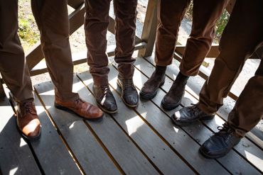 The shoes of a groom and his groomsmen.
