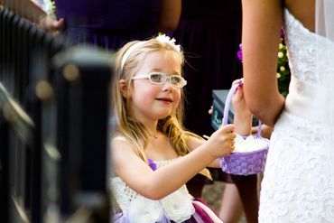 A young flower girls gets ready to walk down the aisle.
