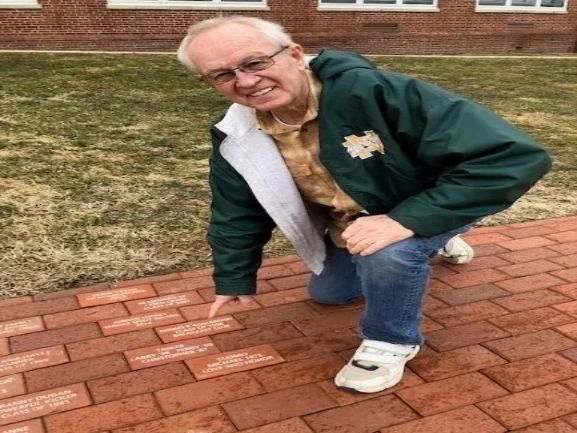 Terry Tasker  with his brick he purchased from the Alumni Association. 