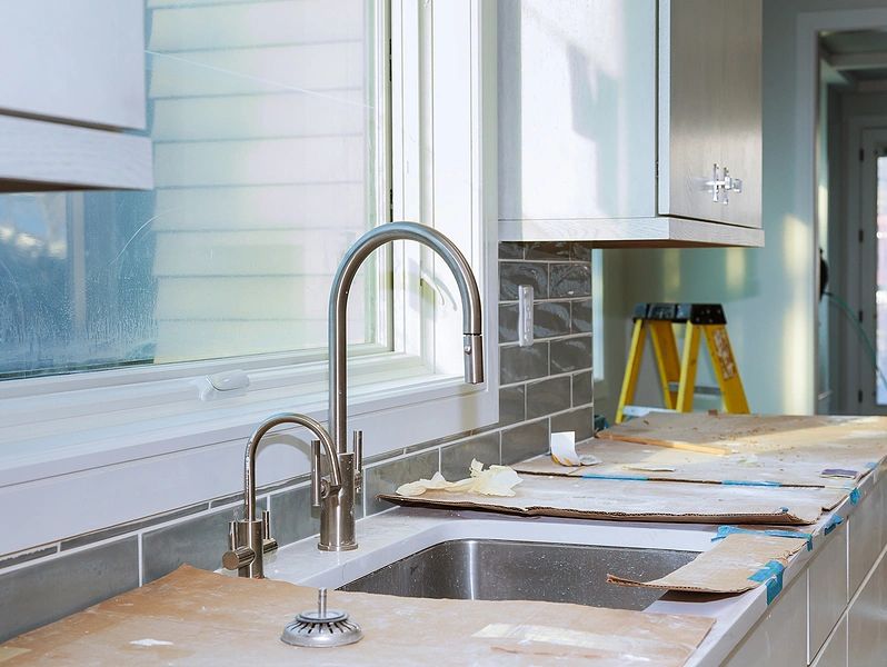 kitchen under renovation with a newly installed sink.