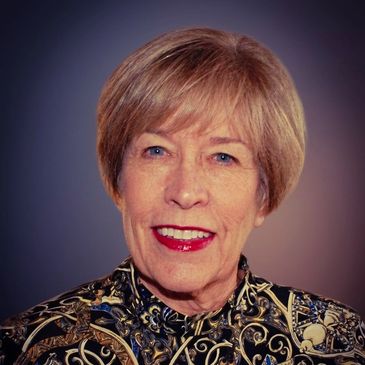 Portrait of an elderly woman with patterned clothing.