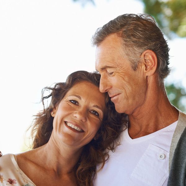 Happy older couple enjoying an intimate moment outdoors.
