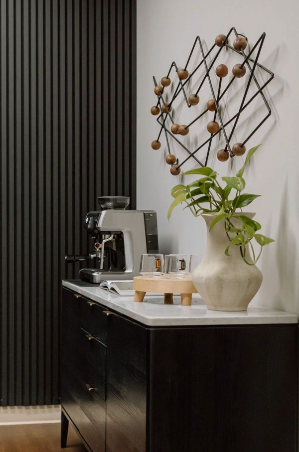 Black reeded wall paneling in kitchen space