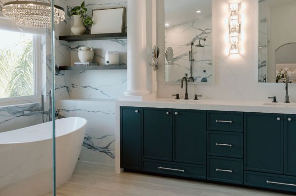 Coastal bath with blue vanity, chrome hardware, oversized LED mirrors