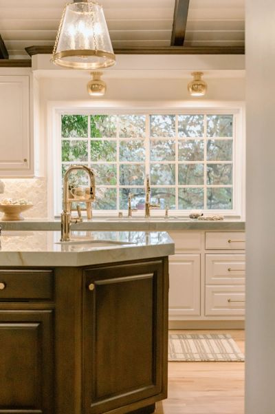 Showcasing our Andasol design project showing new lighting fixtures, beams, quartzite countertops, a