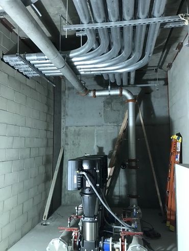 Building water pump room with stainless Victaulic piping installed.