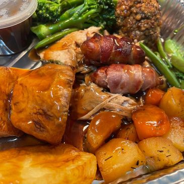 A plate of roasted vegetables, meats, and broccolini.