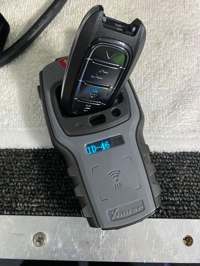 Xhorse device with a car key fob displaying ID-46 on a textured surface.