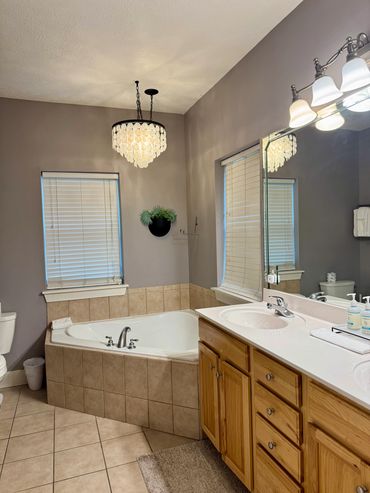 Florida vacation master bath with soaking tub, walk in shower, his and her vanities.
