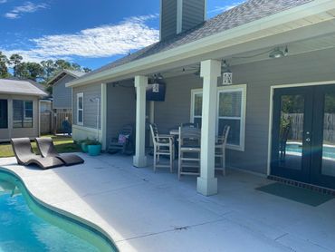 Private backyard relaxing sun soaked getaway. Equipped with grill, lounge pool chairs, umbrella, pat