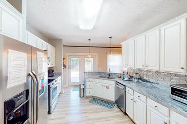 Fully equipped Panama City Beach House rental kitchen with amenities leading to the outdoor private