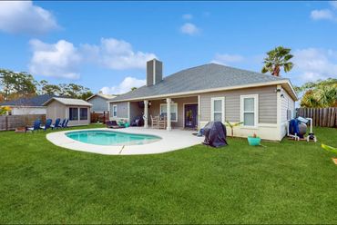 Private Panama City vacation home Back yard oasis with a private pool, grill, patio chairs, reclinin