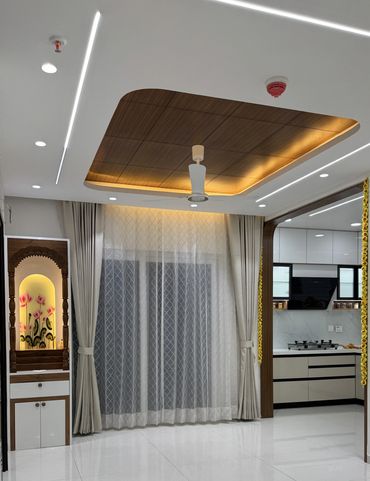Modern living space with ceiling fan and kitchen.