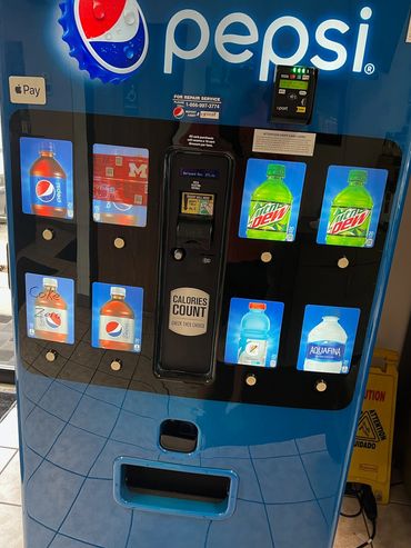 Pepsi vending machine with various soda and water options, including Mountain Dew and Aquafina.