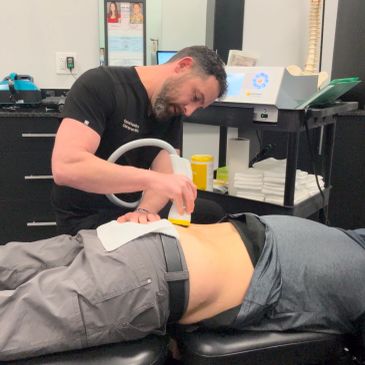 Man receiving low back therapy from a professional.