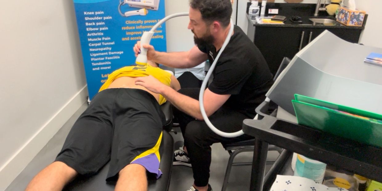 Therapist performing treatment on a patient's back.